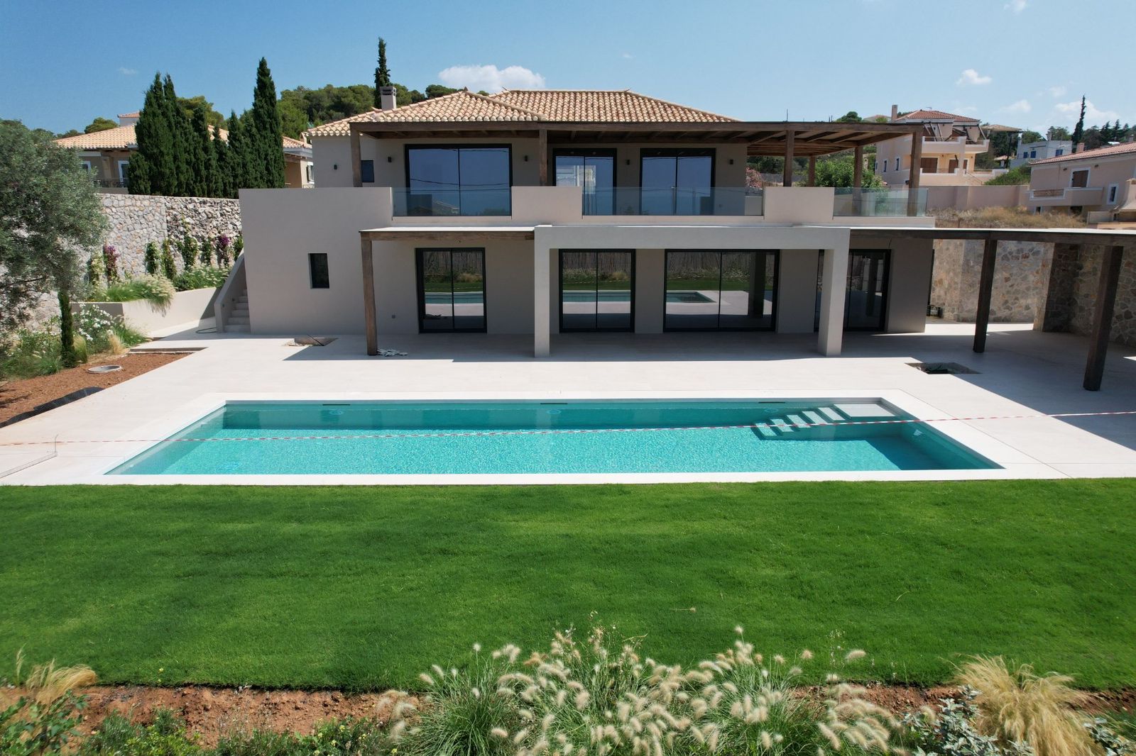 A contemporary hillside villa with pool and sea views in Ermioni